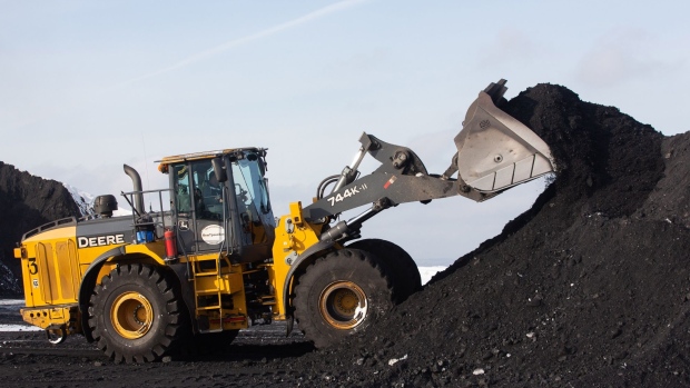 A front loader collects a shovel of coal from a pile at the Raspadsky open-pit coal mine, operated by Raspadskaya PJSC, in Mezhdurechensk, Russia, on Friday, Feb. 5, 2021. Russian steelmaker Evraz Plc is considering options for demerging its Raspadskaya coal business that's valued at about $1.5 billion. Photographer: Andrey Rudakov/Bloomberg