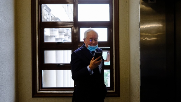 Najib Razak, Malaysia's former prime minister, center, wears a protective mask at the Kuala Lumpur Courts Complex in Kuala Lumpur, Malaysia, on Wednesday, Jan. 6, 2021. Malaysia is still working to recover the $4.5 billion missing from its state fund, with investigations that have led to a massive settlement with Goldman Sachs Group Inc. and a 12-year prison sentence for Najib.
