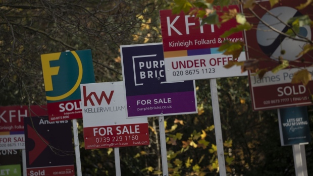 For sale and sold signs for estate agents outside residential flats in the Balham district of London, U.K., on Tuesday, Nov. 24, 2020. Asking prices for U.K. homes slipped this month as owners sought to get sales agreed in time to benefit from a temporary tax cut. Photographer: Simon Dawson/Bloomberg