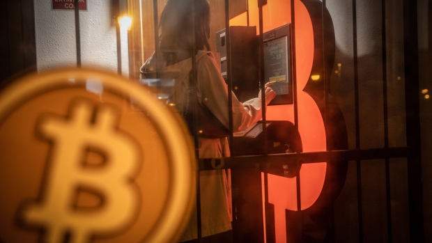 A customer uses a bitcoin automated teller machine (ATM) in a kiosk Barcelona.