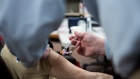 A pharmacist administers a dose of the Covid-19 vaccine in Mountain Brook, Alabama, U.S.,on Sunday, Feb. 21, 2021. In Alabama, the proportion of it's White population getting the Covid-19 vaccine is almost twice that of Black people, according to state data. Photographer: Andi Rice/Bloomberg