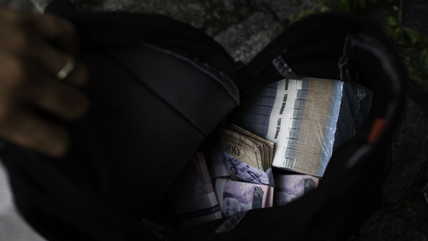 Bolivar notes withdrawn from a bank are seen in a backpack in Caracas, Venezuela, on Wednesday, Nov. 30, 2016. In Venezuela, the economy is shattered, inflation is soaring and the currency has fallen a staggering 67 percent against the U.S. dollar on the black market last month alone -- making 6,000 bolivars worth just $1.30. Photographer: Wil Riera/Bloomberg