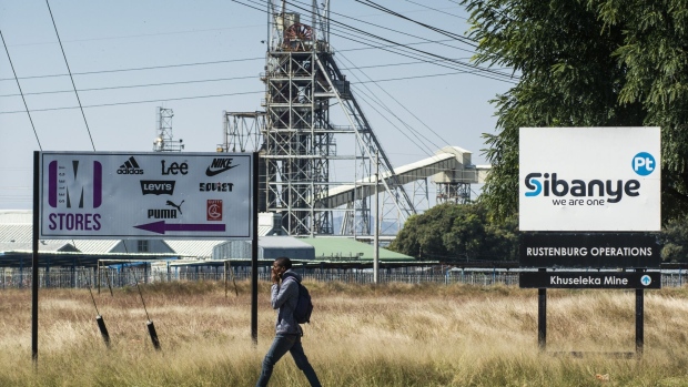 A pedestrian walks along a road as the Sibanye-Stillwater Khuseleka platinum mine, operated by Sibanye Gold Ltd., stands beyond in Rustenburg, South Africa, on Wednesday, April 22, 2020. South Africa allowed mining companies to resume operations at half their normal capacity as the government takes its first steps to ease a nationwide coronavirus lockdown.