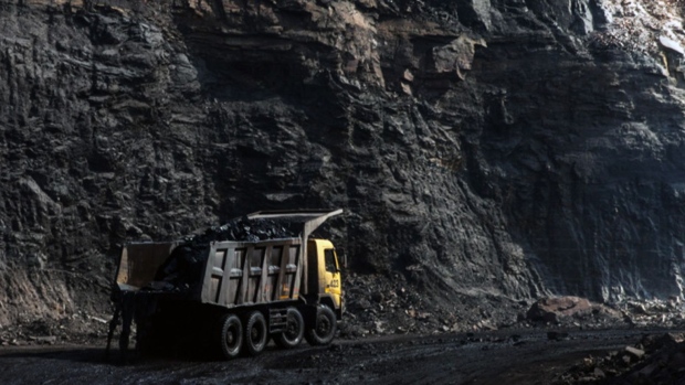 A truck laden with coal travels along a track road in Jharia, Jharkhand, India. Photographer: Sanjit Das/Bloomberg