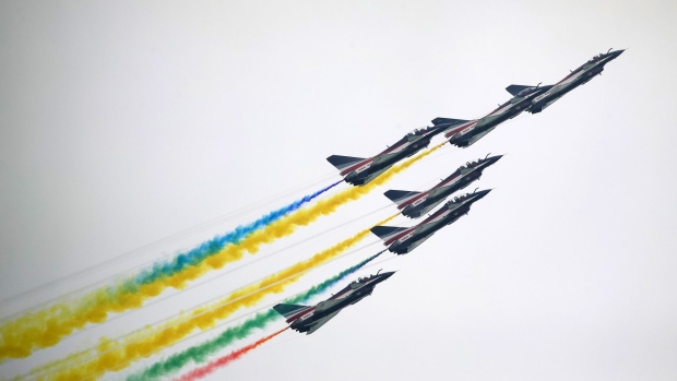 The People's Liberation Army Air Force (PLAAF) August 1st aerobatics team perform maneuvers during a media preview day at the Singapore Airshow held at the Changi Exhibition Centre in Singapore, on Sunday, Feb. 9, 2020. Lockheed Martin Corp and Raytheon Co. are among more than 70 international aviation companies withdrawing from Asia's largest aerospace and defense conference in Singapore as concerns mount over the coronavirus outbreak. Photographer: SeongJoon Cho/Bloomberg