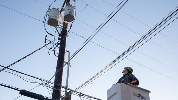 A worker repairs a power line in Austin, Texas, U.S., on Saturday, Feb. 20, 2021. Restaurants in Texas are throwing out expired food, grocery stores are closing early amid stock shortages and residents are struggling to find basic necessities as a cold blast continues to upend supply chains. Photographer: Thomas Ryan Allison/Bloomberg