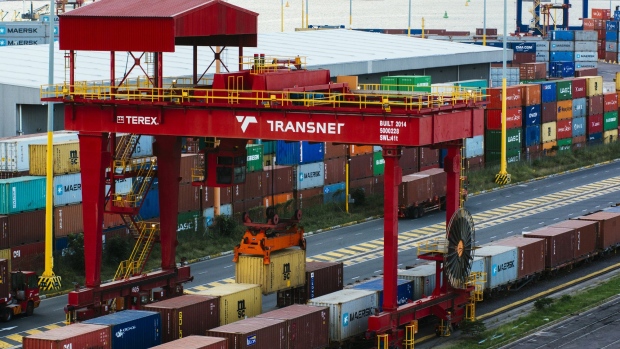 A rail mounted gantry crane lifts a shipping container at the Port of Durban, operated by Transnet SOC Holdings.