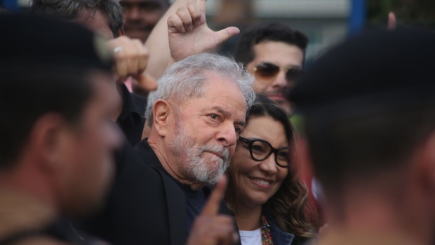 Luiz Inacio Lula da Silva, Brazil's former president, center, greets supporters outside of the Federal Police Headquarters in Curitiba, Brazil, on Friday, Nov. 8, 2019. A judge ordered Lula be released from jail following a high-profile court decision reversing rules for imprisoning convicts.