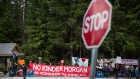 Demonstrators hold during a protest against the Kinder Morgan Canada Ltd. Trans Mountain pipeline expansion., outside of the G7 finance ministers and central bank governors meeting in Whistler, British Columbia, Canada, on Saturday, June 2, 2018. The meeting provides an opportunity for finance and development ministers to advance solutions to issues of shared priority, including women's economic empowerment and mobilizing increased financing for development.