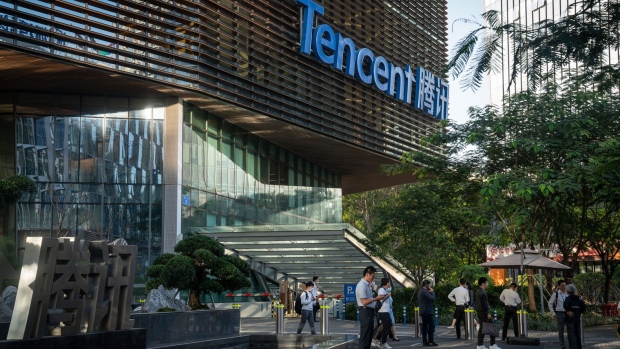 People gather outside the Tencent Binhai Mansion in Shenzhen, China, on Thursday, Nov. 19, 2020. Tencent Holdings Ltd. is investing about $150 million in Waterdrop Inc. to bankroll the Chinese startup’s expansion in health-care crowdfunding, according to people familiar with the matter. Photographer: Yan Cong/Bloomberg