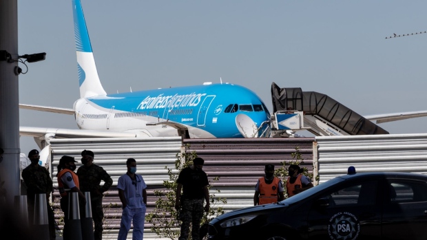 An Aerolineas Argentinas plane arrives carrying the Russian Sputnik V vaccine at Ezeiza International Airport (EZE) airport in Buenos Aires, Argentina, on Thursday, Dec. 24, 2020. Argentina approved the emergency use of Russia's vaccine to combat the spread of Covid-19, becoming the first nation outside the former Soviet Union to authorize the shot.