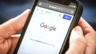 A link to Google's proposal to a workable news code on the company's homepage, arranged on an iPhone in Sydney, Australia, on Friday, Jan. 22, 2021. Google threatened to disable its search engine in Australia if it’s forced to pay local publishers for news, a dramatic escalation of a months-long standoff with the government. Photographer: David Gray/Bloomberg