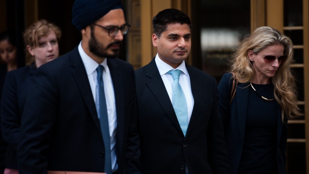 Rohan Ramchandani, former trader at Citigroup Inc., center, leaves federal court in New York, U.S., on Monday, July 17, 2017. Three former British currency traders touched down in New York over the weekend to face charges that they conspired to rig the foreign-exchange market.