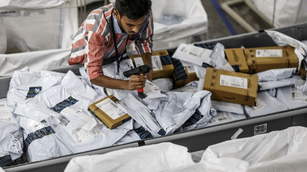 An employee scans a package at the Amazon.com Inc fulfillment center in Hyderabad, India on Thursday, Sept. 7, 2017. Amazon opened its largest Indian fulfillment center in Hyderabad. The center spans 400,000 square feet with 2.1m cubic feet of storage capacity the company said in a statement.