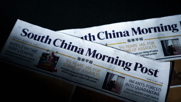 Copies of the South China Morning Post (SCMP) newspapers arranged in Hong Kong, China, on Tuesday, March 16, 2021. The Chinese government wants Alibaba Group Holding Ltd. to sell some of its media assets, including the South China Morning Post, because of growing concerns about the technology giant’s influence over public opinion in the country, according to a person familiar with the matter. Photographer: Lam Yik/Bloomberg