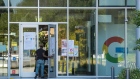 A person walks into a building at the Google campus in Mountain View, California, U.S., on Monday, July 27, 2020. Alphabet Inc.'s Google will let employees work from home until July 2021, once again pushing back the re-opening of its offices as the coronavirus continues to rage in many parts of the U.S. Photographer: David Paul Morris/Bloomberg