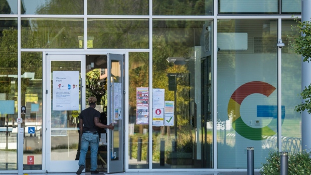 A person walks into a building at the Google campus in Mountain View, California, U.S., on Monday, July 27, 2020. Alphabet Inc.'s Google will let employees work from home until July 2021, once again pushing back the re-opening of its offices as the coronavirus continues to rage in many parts of the U.S. Photographer: David Paul Morris/Bloomberg