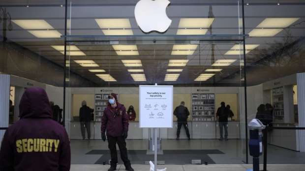 The Apple Inc logo at a store in San Francisco, California, U.S., on Friday, Oct. 23, 2020. The iPhone 12 and iPhone 12 Pro went on sale in stores, but with individual shopping sessions replacing the famous lines and crowds around locations. Photographer: David Paul Morris/Bloomberg