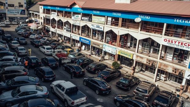 Automobiles sit parked at the Emab Plaza commercial hub in Abuja, Nigeria, on Friday, Jan. 10, 2020. Revenue in Nigeria has fallen short of the government target by at least 45% every year since 2015, and shortfalls have been funded through increased borrowing. Photographer: KC Nwakalor/Bloomberg