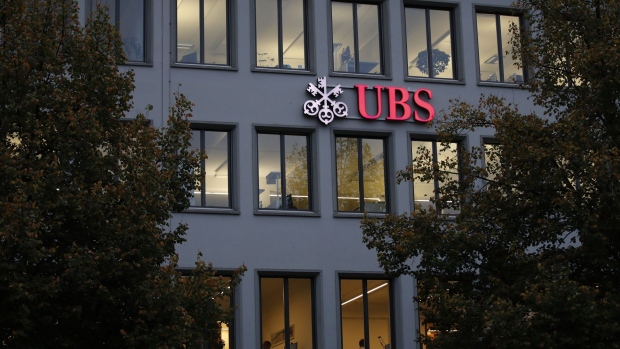An illuminated logo sits on display outside the UBS Group AG offices in Zurich, Switzerland, on Tuesday, Oct. 22, 2019. UBS’s rich clients added $15.7 billion in new money last quarter, giving a boost to star hire Iqbal Khan as he seeks to reinvigorate the key wealth management unit. Photographer: Stefan Wermuth/Bloomberg