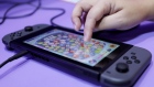 An attendant uses a Nintendo Co. Switch game console to demonstrate the Disney Tsum Tsum Festival video game in the Bandai Namco Entertainment Inc. booth at the Tokyo Game Show 2019 in Chiba, Japan, on Thursday, Sept. 12, 2019. Over 650 companies and groups are exhibiting at the annual game show, which runs through Sept. 15. Photographer: Kiyoshi Ota/Bloomberg