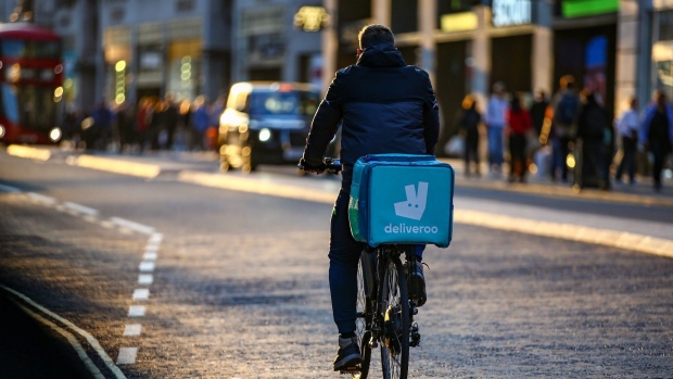 A takeaway food courier, working for Deliveroo, operated by Roofoods Ltd., cycles along Oxford Street in central London, U.K., on Tuesday, Sept. 29, 2020. Covid-19 lockdown enabled online and app-based grocery delivery service providers to make inroads with customers they had previously struggled to recruit, according the Consumer Radar report by BloombergNEF.