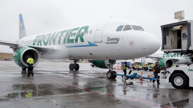 Ground operations employees prepare a Frontier Airlines Inc. plane for takeoff at Denver International Airport (DIA) in Denver, Colorado, U.S., on Tuesday, April 4, 2017. Frontier Airlines Inc., the no-frills U.S. carrier whose aircraft feature animals on the tails, is aiming to go public as soon as the second quarter, people with knowledge of the matter said. Photographer: Matthew Staver/Bloomberg