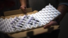 A box of Pfizer-BioNTech Covid-19 vaccines is opened after delivery to the Ambroise Pare Clinic in Paris, France, on Wednesday, Jan. 6, 2021.