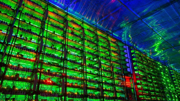 Illuminated mining rigs operate inside racks at the CryptoUniverse cryptocurrency mining farm in Nadvoitsy, Russia, on Thursday, March 18, 2021. The rise of Bitcoin and other cryptocurrencies has prompted the greatest push yet among central banks to develop their own digital currencies. Photographer: Andrey Rudakov/Bloomberg