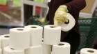 A volunteer picks up rolls of toilet paper at a Midwest Food Bank distribution warehouse in Normal, Illinois, U.S., on Wednesday, May 13, 2020. The coronavirus pandemic is forcing food banks across the country to find new ways to feed people — from slaughtering animals to enlisting car dealerships and unemployed restaurant workers to serve homebound clients. Photographer: Daniel Acker/Bloomberg