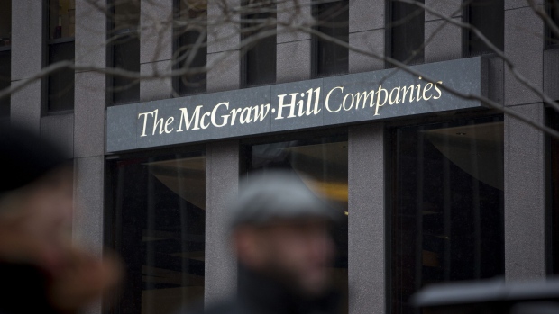 Pedestrians pass in front of McGraw-Hill Cos. headquarters in New York. McGraw-Hill is focusing on its ratings and financial software business after agreeing to sell its education unit to Apollo Global Management LLC for $2.5 billion in November, which is expected to close by the end of March.