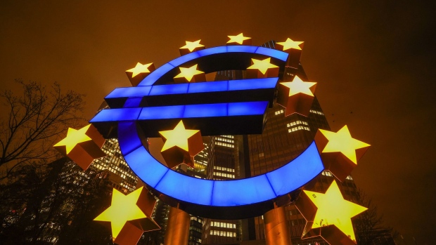 The Euro sculpture illuminated outside the Eurotower, the former headquarters of the European Central Bank (ECB) in Frankfurt, Germany, on Tuesday, Dec. 15, 2020. ECB Supervisory Board Chairman Andrea Enria said that the ECB is enabling payment of dividends within limits. Photographer: Alex Kraus/Bloomberg