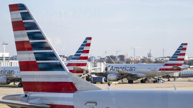American Airlines Group Inc. aircraft at Ronald Reagan National Airport (DCA) in Arlington, Virginia, U.S., on Wednesday, Nov. 25, 2020. While passenger volumes are less than 40% of last year’s levels, late demand for holiday travel has been driven by fares that are substantially lower than typical as airlines desperately try to fill seats during the coronavirus pandemic.