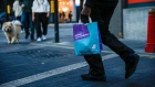 A takeaway food courier, working for Deliveroo, operated by Roofoods Ltd., walks with a customer's food order in London, U.K., on Tuesday, Sept. 29, 2020. Covid-19 lockdown enabled online and app-based grocery delivery service providers to make inroads with customers they had previously struggled to recruit, according the Consumer Radar report by BloombergNEF. Photographer: Hollie Adams/Bloomberg