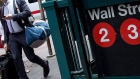 A pedestrian walks past the Wall Street subway station near New York Stock Exchange. Photographer: Michael Nagle/Bloomberg