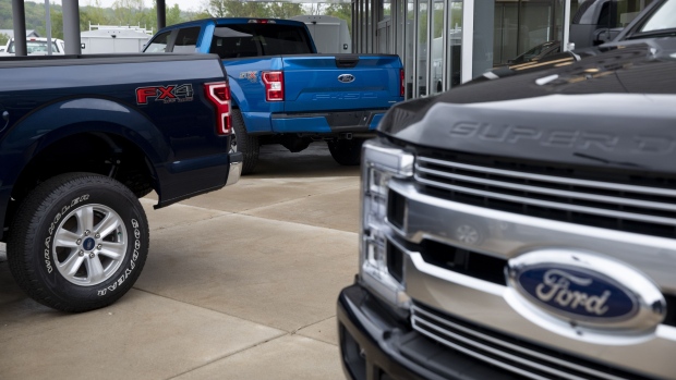 2020 Ford Motor Co. F-150 trucks sit on display at a car dealership in Peoria, Illinois, U.S., on Thursday, May 14, 2020. With losses mounting and North American factories idle in the face of coronavirus shutdowns, Ford shareholders gathered for their virtual annual meeting Thursday. Photographer: Daniel Acker/Bloomberg
