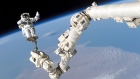 An Astronaut is anchored to the Canadarm2 on the International Space Station.