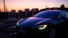 A Tesla Inc. Model S electric vehicle drives away from illuminated Supercharger stations at night in Sant Cugat, Spain, on Wednesday, July 10, 2019. Tesla is poised to increase production at its California car plant and is back in hiring mode, according to an internal email sent days after the company wrapped up a record quarter of deliveries. Photographer: Angel Garcia/Bloomberg