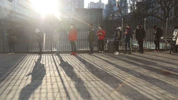 Students wait in line to enter a New York City public high school in New York, U.S., on Monday, March 22, 2021. Children in the U.S., Mexico and India are among those who have been shut out of schools longest, while those in France and Switzerland suffered only a few weeks of distance learning before returning to classrooms, according to the latest data from Unesco, which has been monitoring the disruption to education. Photographer: Angus Mordant/Bloomberg