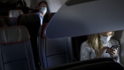 Passengers wear protective masks sit on a Boeing Co. 737-800 during an American Airlines Group Inc. flight departing from Los Angeles International Airport (LAX) Los Angeles, California, U.S., on Saturday, June 13, 2020. The market for jet fuel, along with an increase in flight bookings since early May, is signaling that at least some Americans are ready to take to the skies again after foregoing the pleasures of travel.
