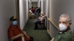 TORONTO, ON - APRIL 01: Seniors sit in the hallway following being administered their second dose of the Pfizer COVID-19 vaccine by healthcare workers from Humber River Hospital, inside Caboto Terrace, an independent seniors residence, on April 1, 2021 in Toronto, Canada. As health care providers continue their vaccine rollout efforts, Ontario's Premier Doug Ford is set to announce a hard month-long lockdown in the province in an effort to control coronavirus variants of concern.(Photo by Cole Burston/Getty Images)