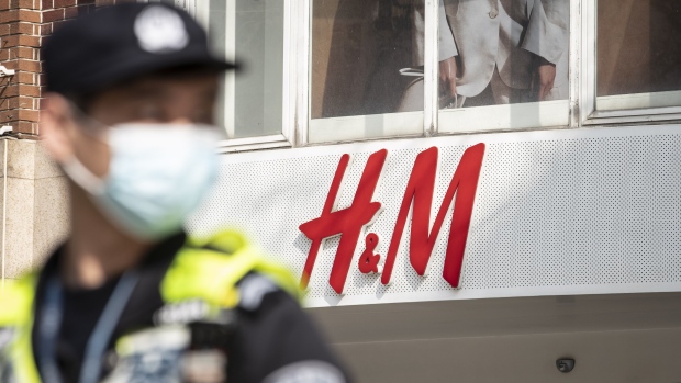 A traffic officer patrols the street in front of a Hennes & Mauritz AB (H&M) store in Shanghai, China, on Friday, March 26, 2021. China this week has pushed a campaign to boycott Western retailers after the U.S., U.K., Canada and the European Union imposed sanctions over human-rights abuses against ethnic minority Uyghurs in Xinjiang. Photographer: Qilai Shen/Bloomberg