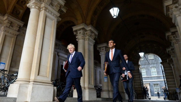 Boris Johnson, U.K. prime minister, left, and Rishi Sunak, U.K. chancellor of the exchequer, center, arrives for a weekly meeting of cabinet ministers in London, U.K., on Tuesday, Oct. 13, 2020. U.K. Prime Minister Boris Johnson announced bars and pubs will be closed in the worst-hit parts of England from Wednesday to control a surge in coronavirus, but his top health adviser said it won’t be enough.