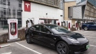 A Tesla Inc. electric vehicle is parked next to charging stations outside one of the company's showrooms in Beijing China, on Saturday, March 6, 2021
