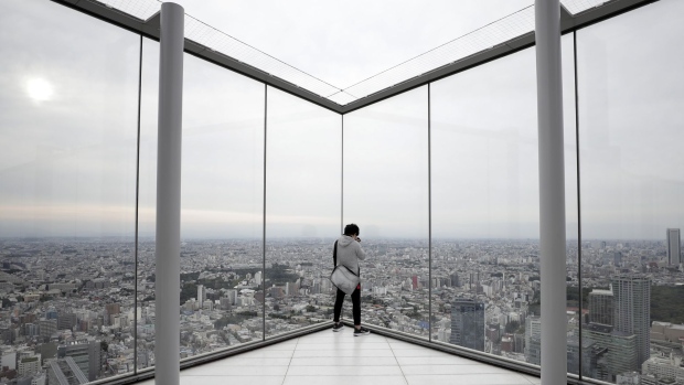 A visitor takes a photograph of the view at the Shibuya Sky observation deck of the Shibuya Scramble Square building in Tokyo, Japan, on Tuesday, Sept. 29, 2020. The Bank of Japan (BOJ) will release its quarterly Tankan business sentiment survey on Oct. 1. Photographer: Kiyoshi Ota/Bloomberg