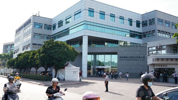 People enter the Hon Hai Precision Industry Co. headquarters ahead of the company's annual general meeting in New Taipei City, Taiwan, on Tuesday, June 23, 2020. Hon Hai, the main assembler of Apple Inc.'s iPhone, is planning to make fresh investment in India "within months," Chairman Young Liu told investors at the meeting.