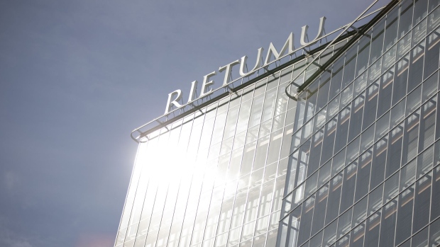 Sunlight reflects on office windows at the headquarters of Rietumu Banka AS in Riga, Latvia.