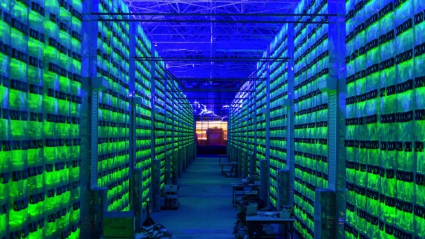 Illuminated mining rigs operate inside racks at the CryptoUniverse cryptocurrency mining farm in Nadvoitsy, Russia, on Thursday, March 18, 2021. The rise of Bitcoin and other cryptocurrencies has prompted the greatest push yet among central banks to develop their own digital currencies. Photographer: Andrey Rudakov/Bloomberg