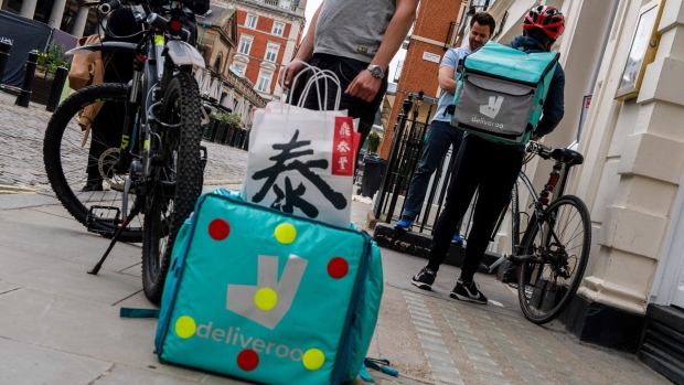 Food delivery couriers for Deliveroo Holdings Plc collect orders from a restaurant in Covent Garden, London, U.K., on Wednesday, March 31, 2021. Food-delivery startup Deliveroo Holdings Plc sank as much as 31% in its London debut after its initial public offering raised 1.5 billion pounds ($2.1 billion), putting pressure on the Citys efforts to boost its profile as a technology and listings hub post-Brexit. Photographer: Chris J. Ratcliffe/Bloomberg