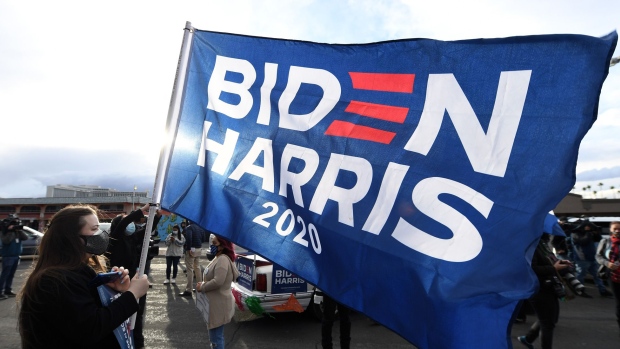 LAS VEGAS, NEVADA - NOVEMBER 07: Melissa Vandervort of Nevada carries a Biden-Harris flag as supporters of Joe Biden prepare to hold a car parade to celebrate the outcome of Tuesday's election on November 7, 2020 in Las Vegas, Nevada. Supporters around the country are taking to the streets to celebrate after news outlets have declared Democratic presidential nominee Joe Biden winner over President Donald Trump in the U.S. Presidential race. (Photo by Ethan Miller/Getty Images) Photographer: Ethan Miller/Getty Images North America